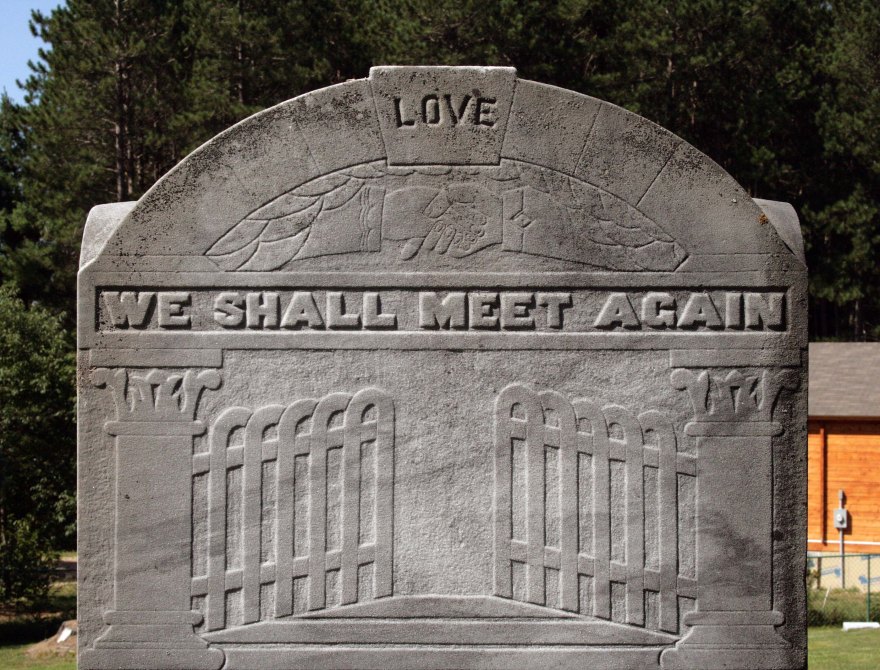 The gates ajar engraved on a grey tombstone