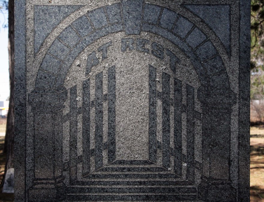 The gates ajar on a gravestone